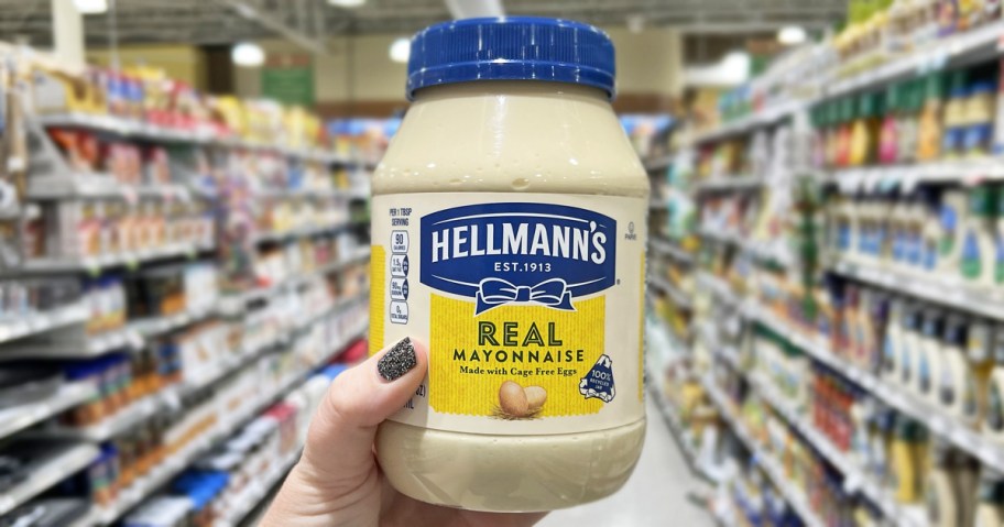 hand holding up a jar of Hellmann's Mayonnaise in store