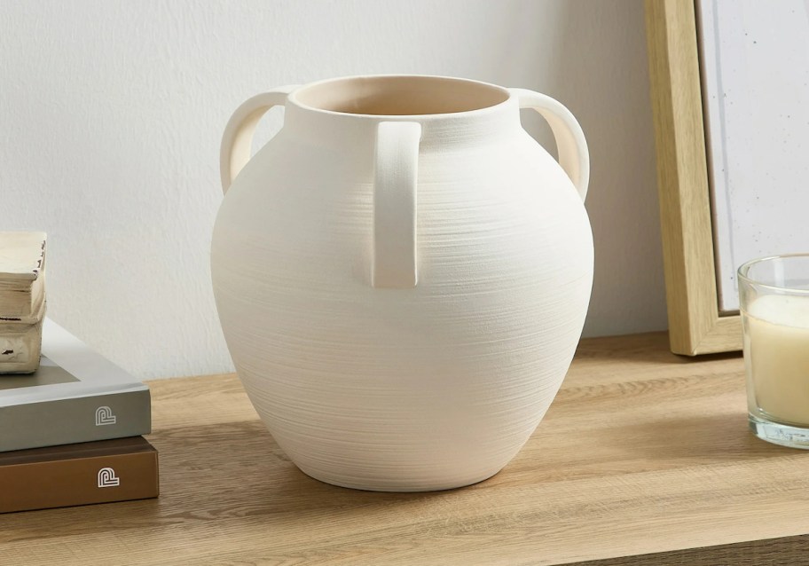 ivory colored ceramic vase on table