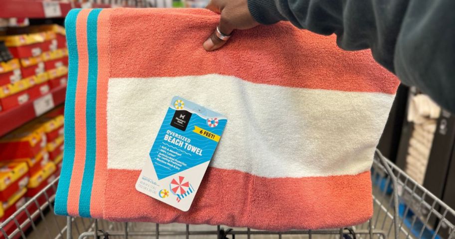 Hand holding a member's mark oversized cabana striped beach towel