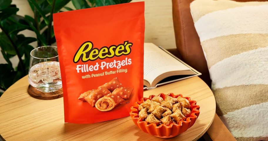 orange bag of Reese's Filled Pretzels side table near bowl of pretzels