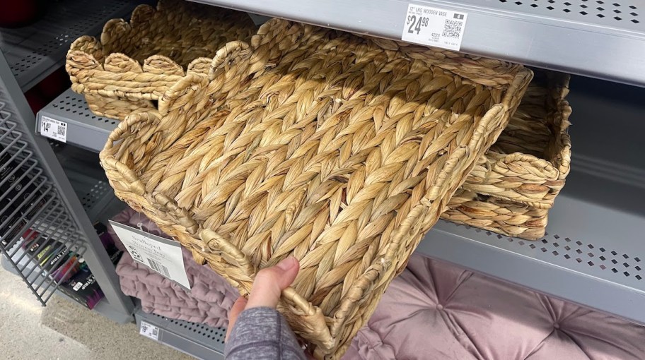 hand holding scalloped woven basket tray on store shelf