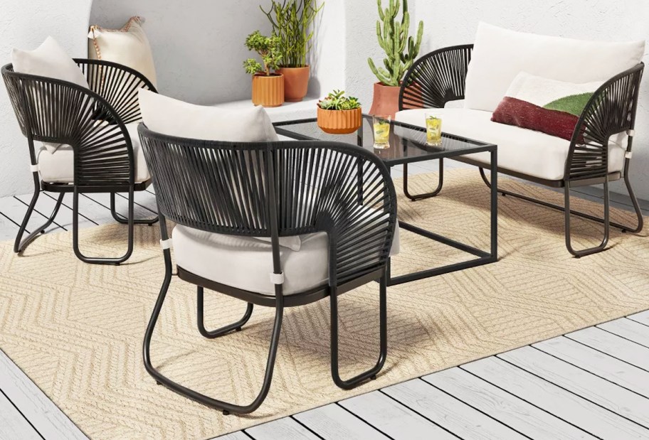 black rope club chairs and loveseat with white cushions
