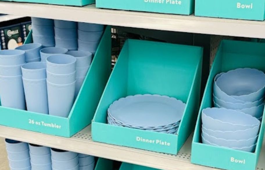 a store end cap shelf filled with various scalloped plastic dinnerware