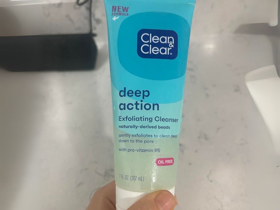 Clean & Clear Deep Action Exfoliating Facial Cleanser in hand in bathroom