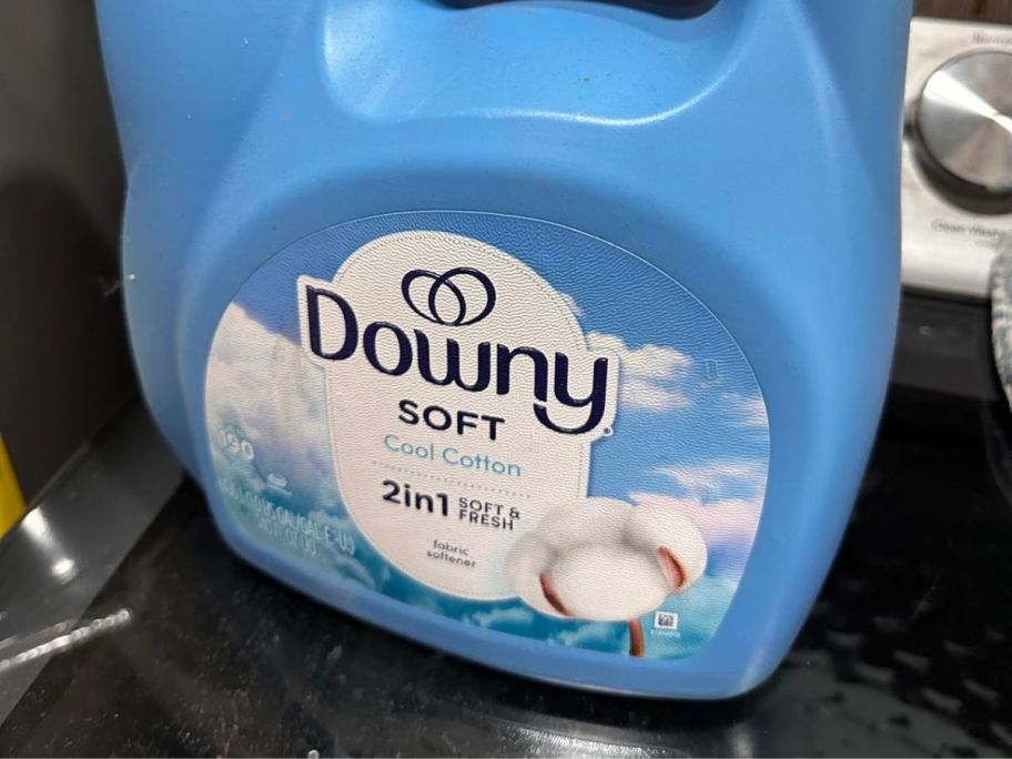 Downy Fabric Softener Liquid 140oz bottle on washing machine