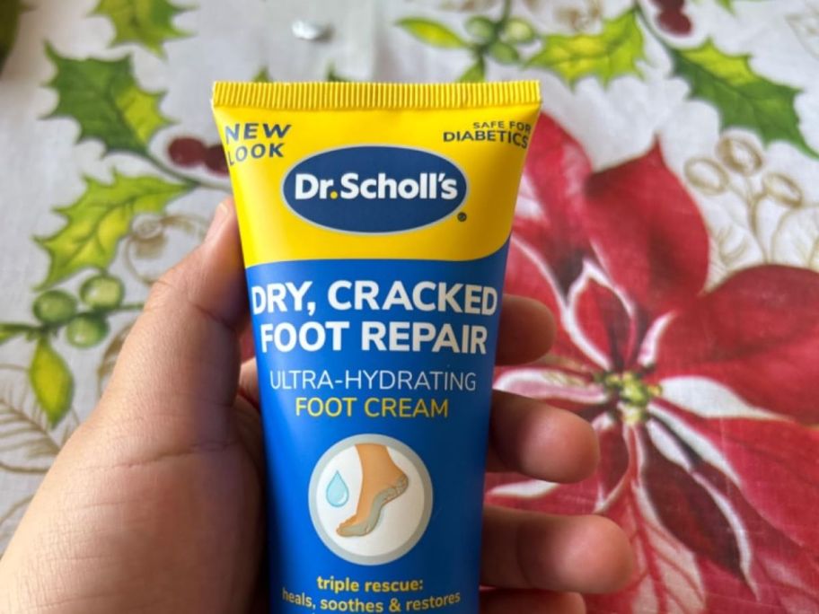 holding a bottle of foot lotion
