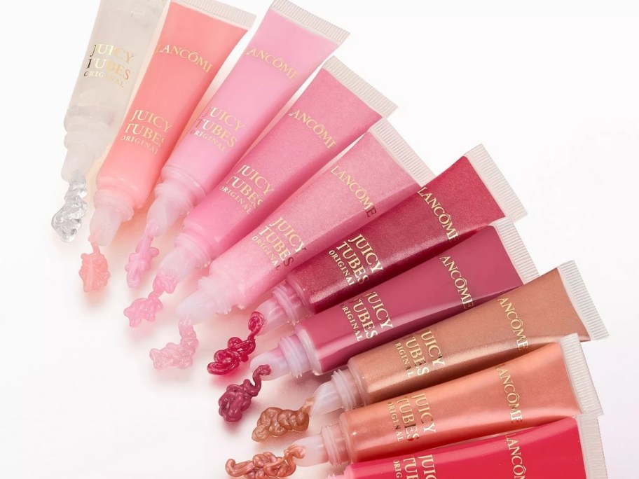 ten tubes of lip gloss in various colors fanned out to display