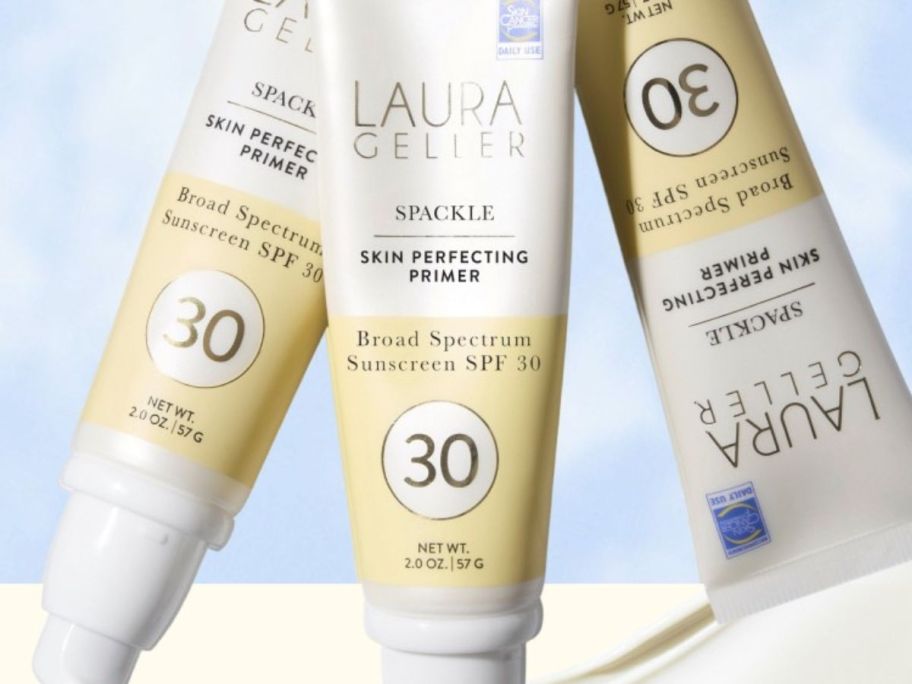 three laura gellar SPF in front of a blue color