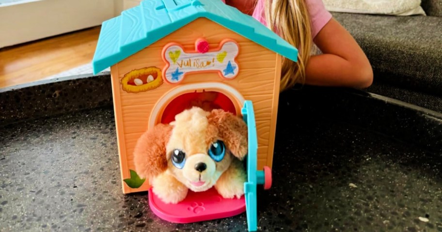 plush puppy in a toy doghouse