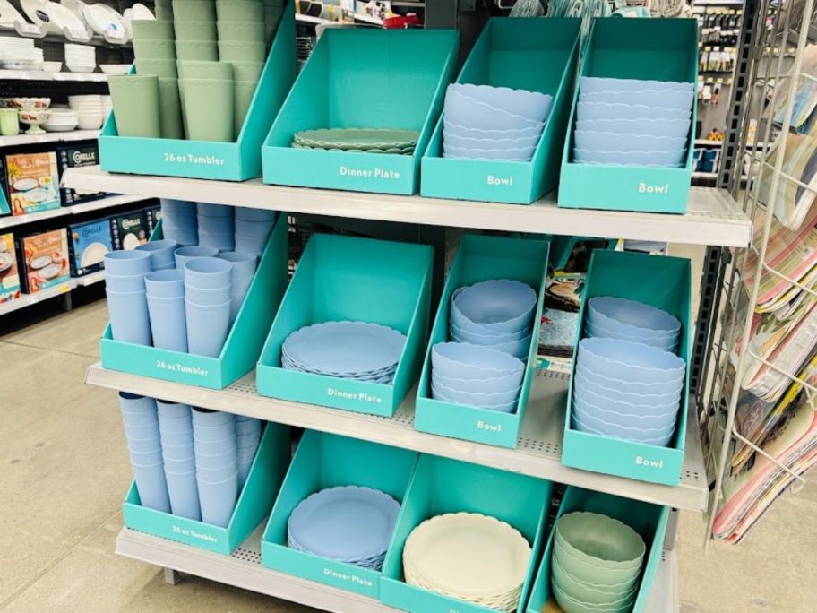 a store endcap filled with various types of plastic dinnerware