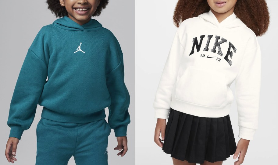 two girls wearing teal and white nike hoodies
