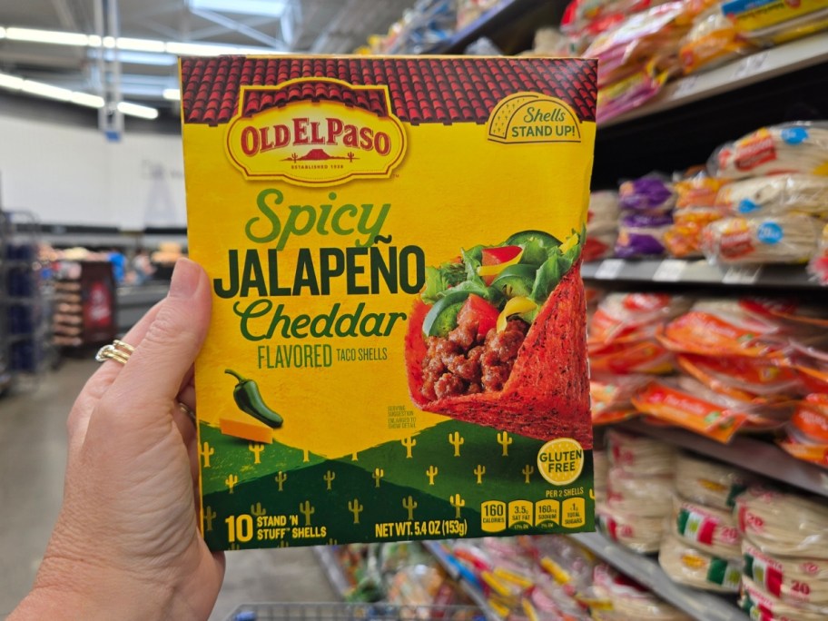 hand holding a box of Old El Paso Spicy Jalapeño Cheddar Flavored Stand 'N Stuff Taco Shells