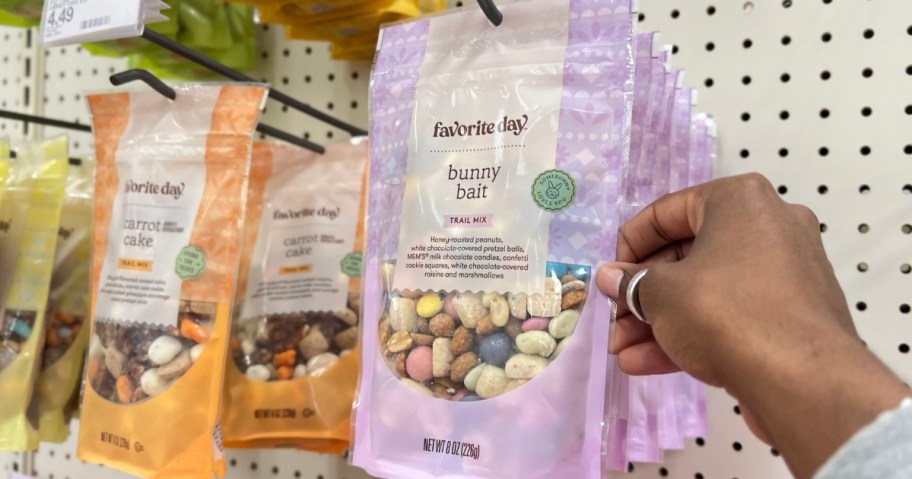 hand reaching for a bag of Easter trail mix on a store wall
