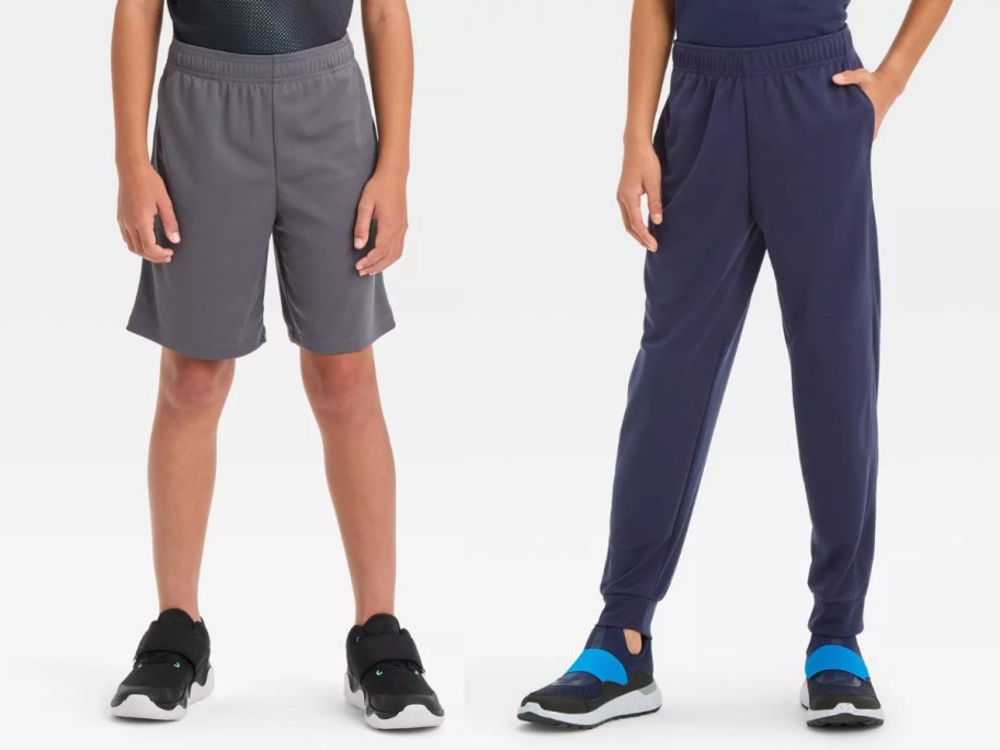 boy wearing grey shorts and boy wearing navy blue jogger pants