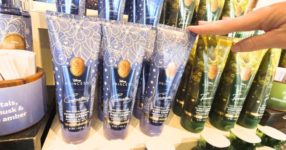 hand reaching for disney princess body creams 