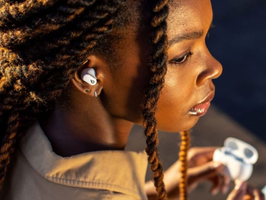Woman using Beats Studio Buds 