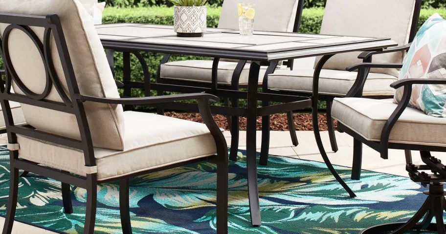 patio dining table with chairs around it