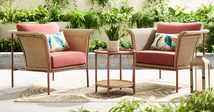 wicker chairs with red cushions and red side table