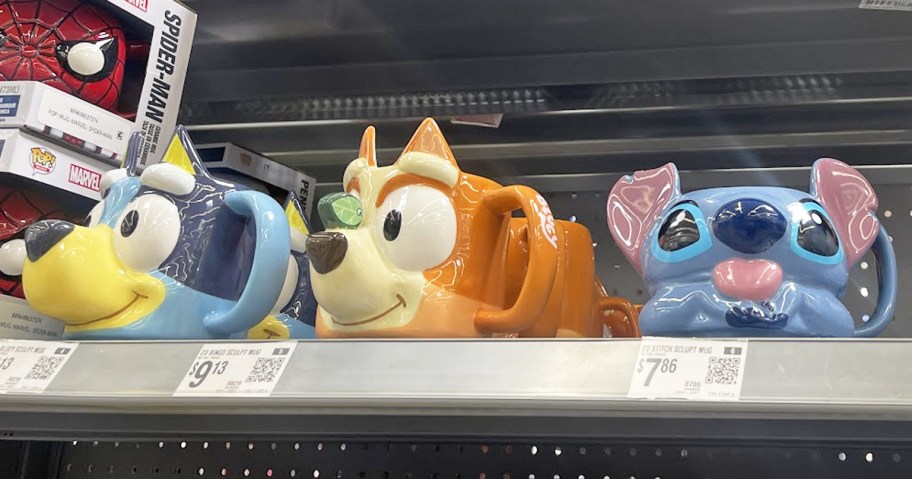 bluey, bingo, and stitch shaped coffee mugs on store shelf 