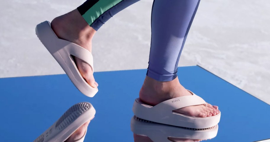 woman wearing platform flip flops on a mirrored surface