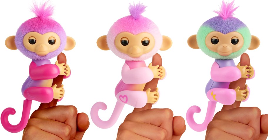 three pink monkey toys on fingers