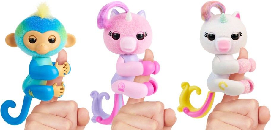 three monkey and unicorn toys on fingers