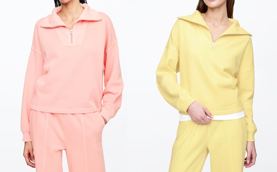 two women in pink and yellow quarter zip sweatshirts