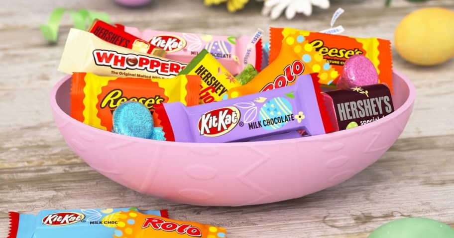 a pink bowl filled with individual Hershey's miniature candies and Hershey's Kisses