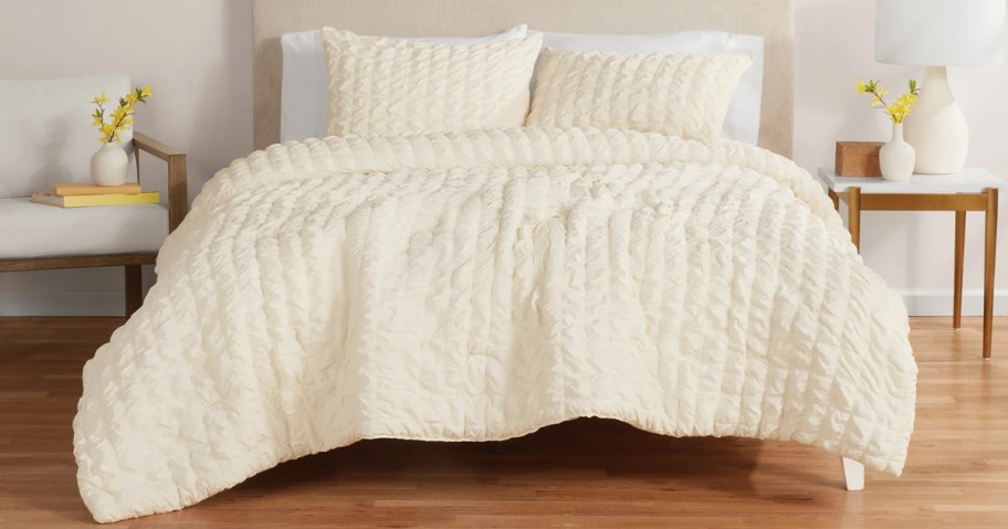 white comforter and shams set on bed