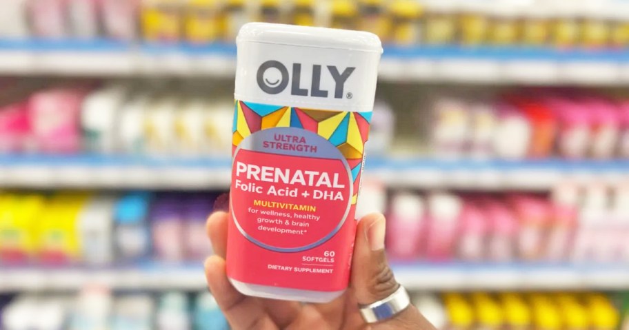 hand holding up a bottle of OLLY Ultra Strength Prenatal Multivitamin in store