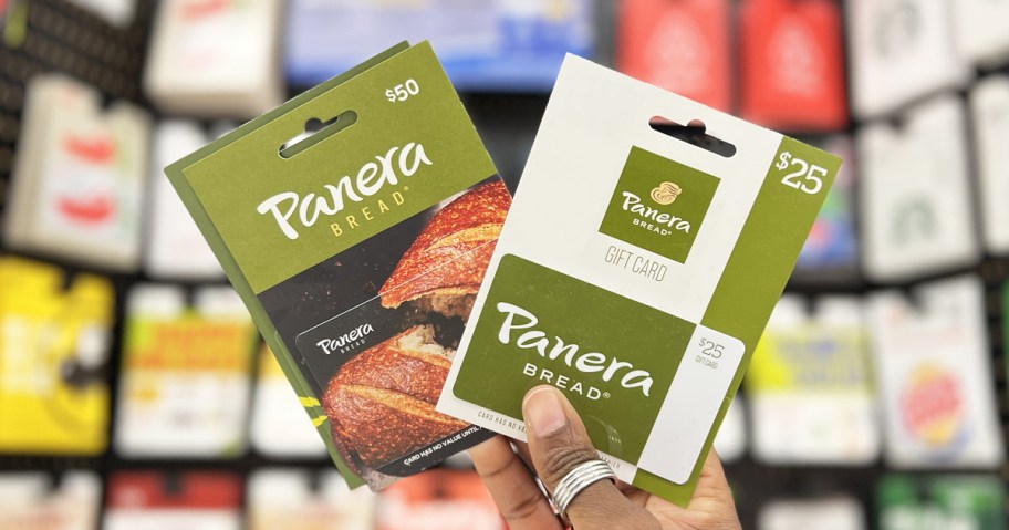 hand holding up two panera gift cards