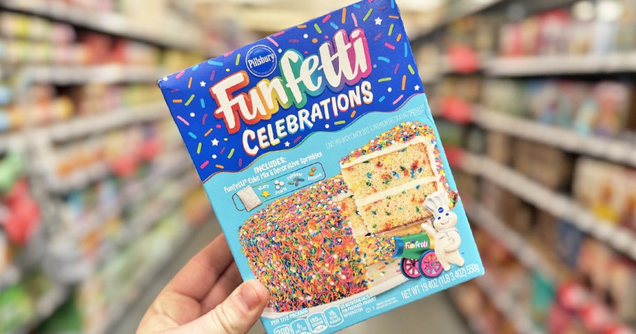 hand holding up a box of Pillsbury Funfetti Celebrations Cake Mix in store
