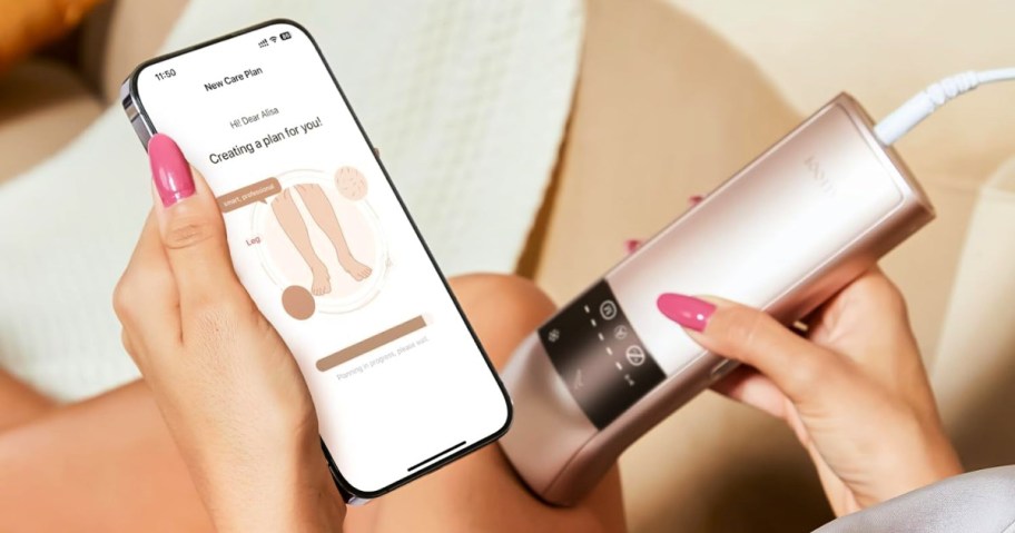 woman using a Salloot IPL Laser Hair Remover on her leg and holding a phone