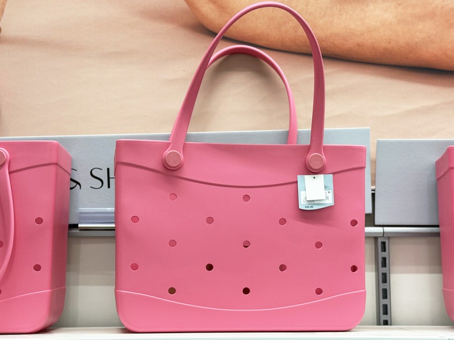pink tote bags with holes on store shelf