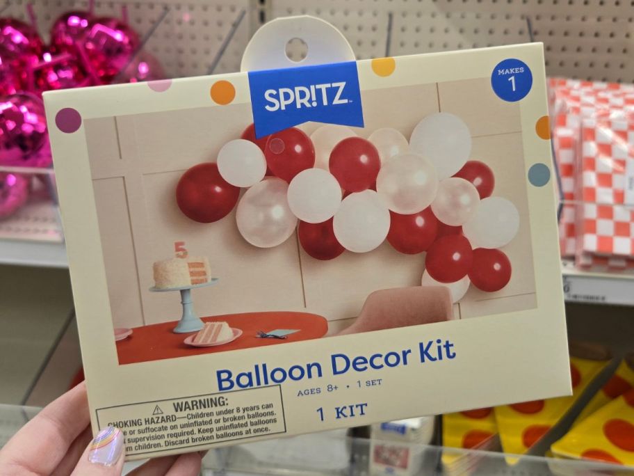 Hand holding a Spritz Target Red & White Balloon Arch Garland