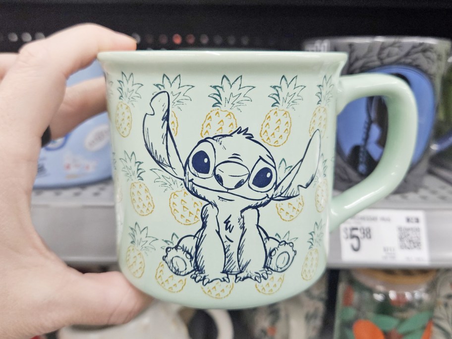 hand holding up a stitch pineapple print coffee mug