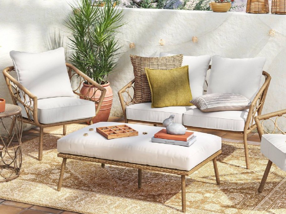 loveseat patio chair on a rug with center table displayed