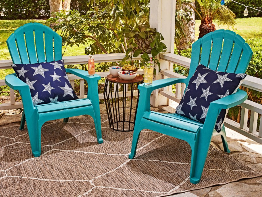 two blue chairs with star cushions on a front porch