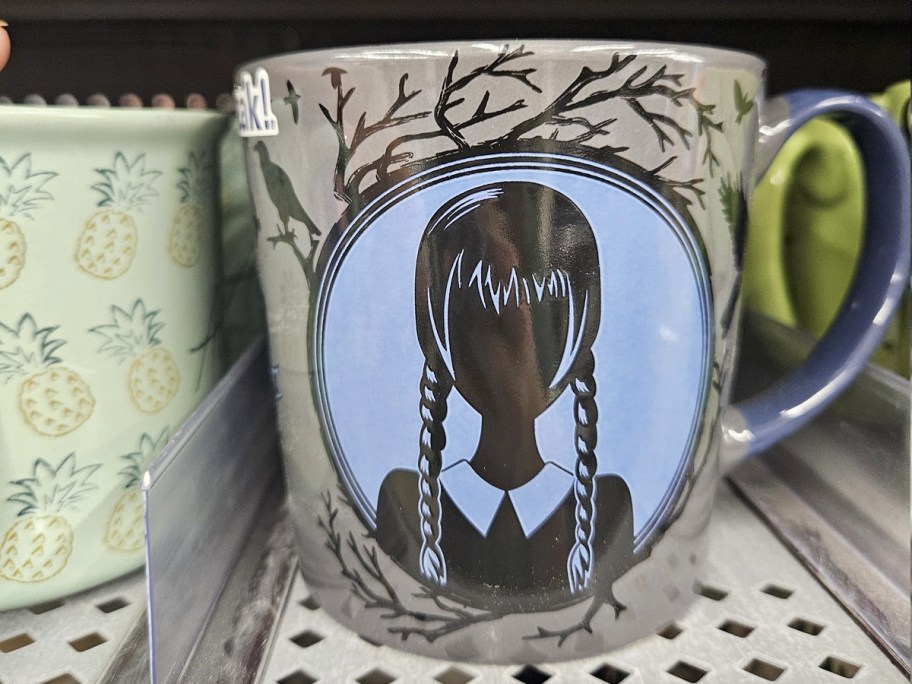 Wednesday Addams coffee mug on store shelf