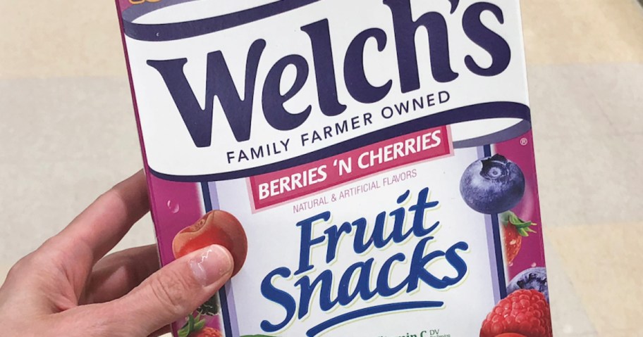 hand holding box of fruit snacks