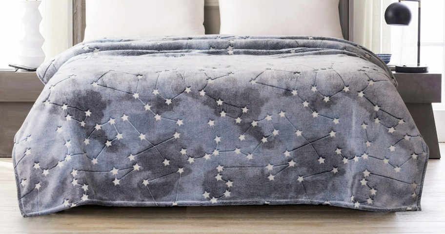 grey constellation print throw blanket on bed