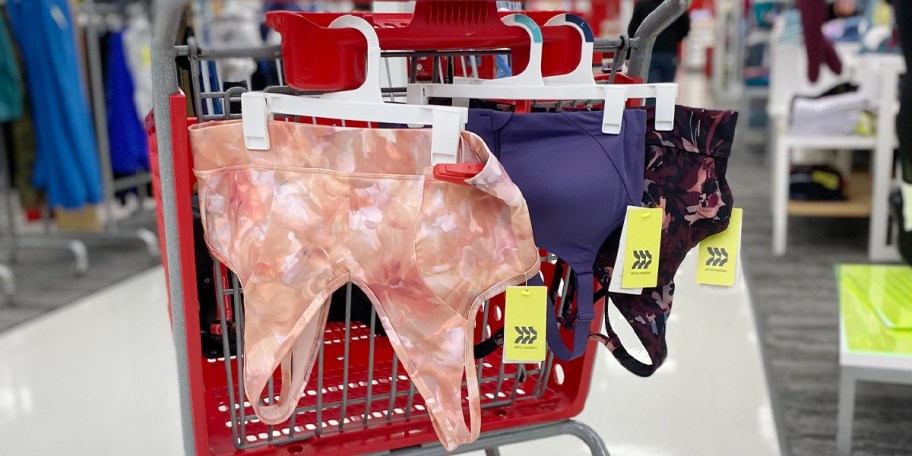 three sports bras hanging on target shopping cart