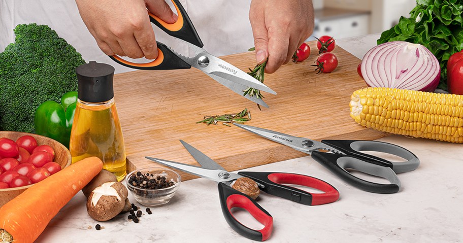 person in kitchen preparing a meal and using kitchen shears