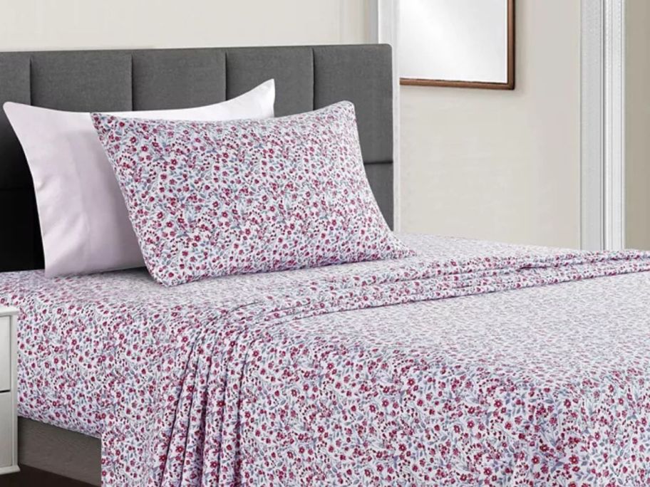 pink floral bed sheets on bed in bedroom