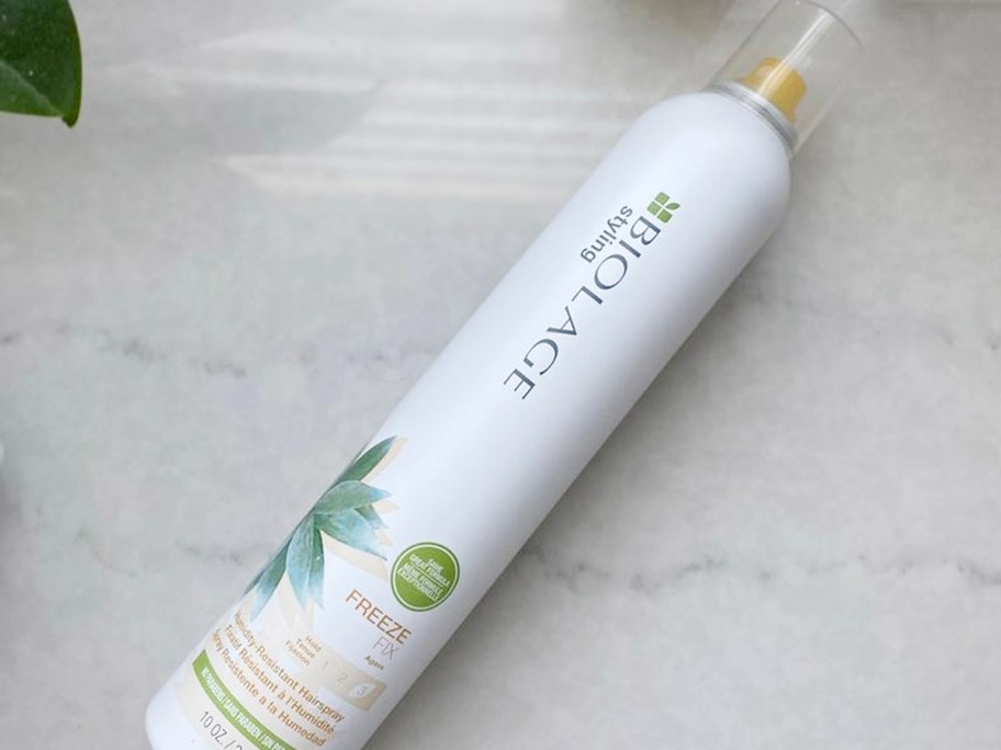 biolage hair spray bottle laying on table