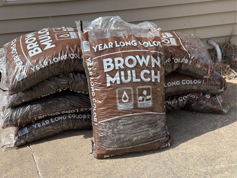 various brown mulch bags stacked outside