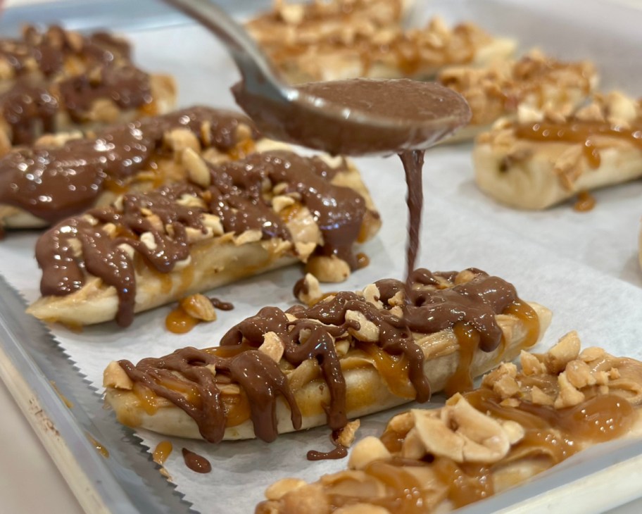 drizzling chocolate over frozen bananas