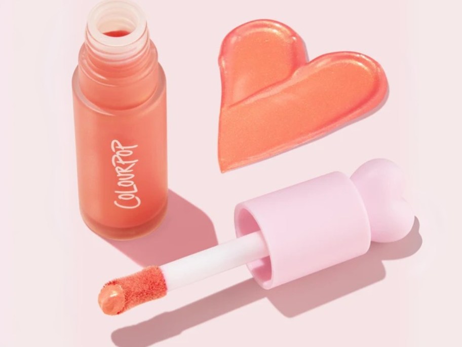 a ColourPop lip gloss tube open with some spread out in the shape of a heart