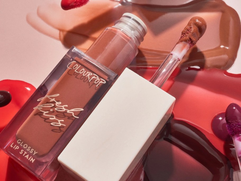 a ColourPop lip gloss tube open with lip gloss spread out 