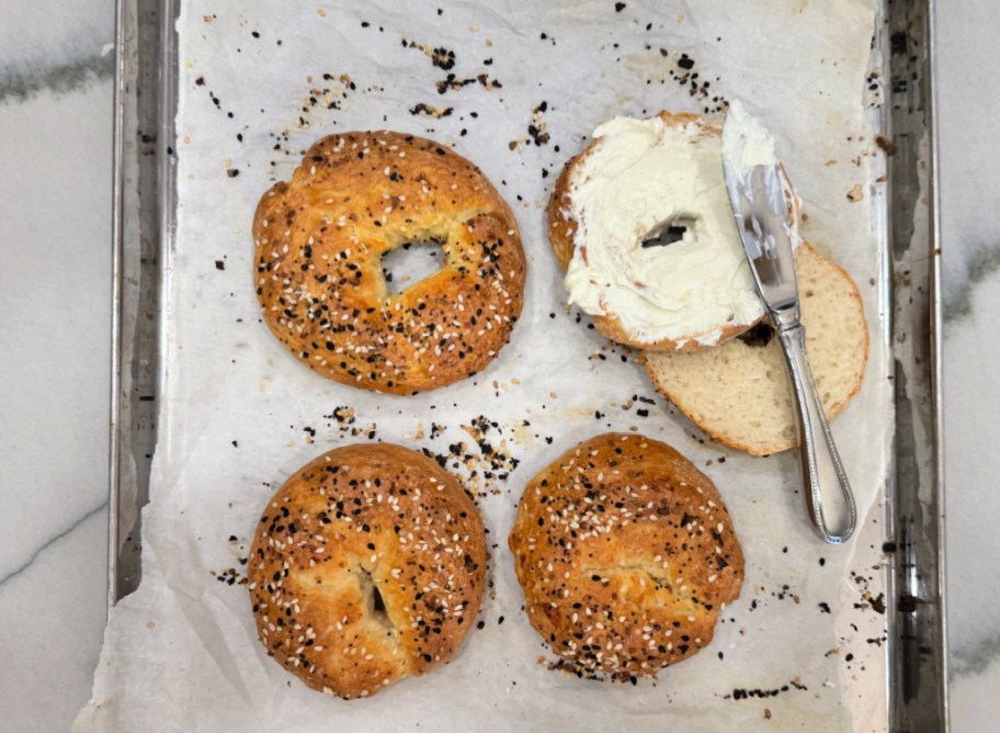 cottage cheese bagel on a sheet pan with cream cheese